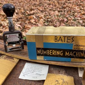 Bates numbering stamp + original box